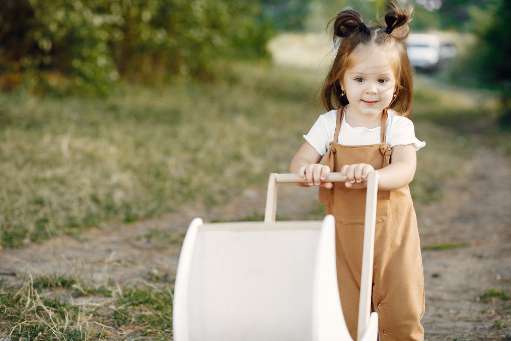 Baby pushing the wooden walker