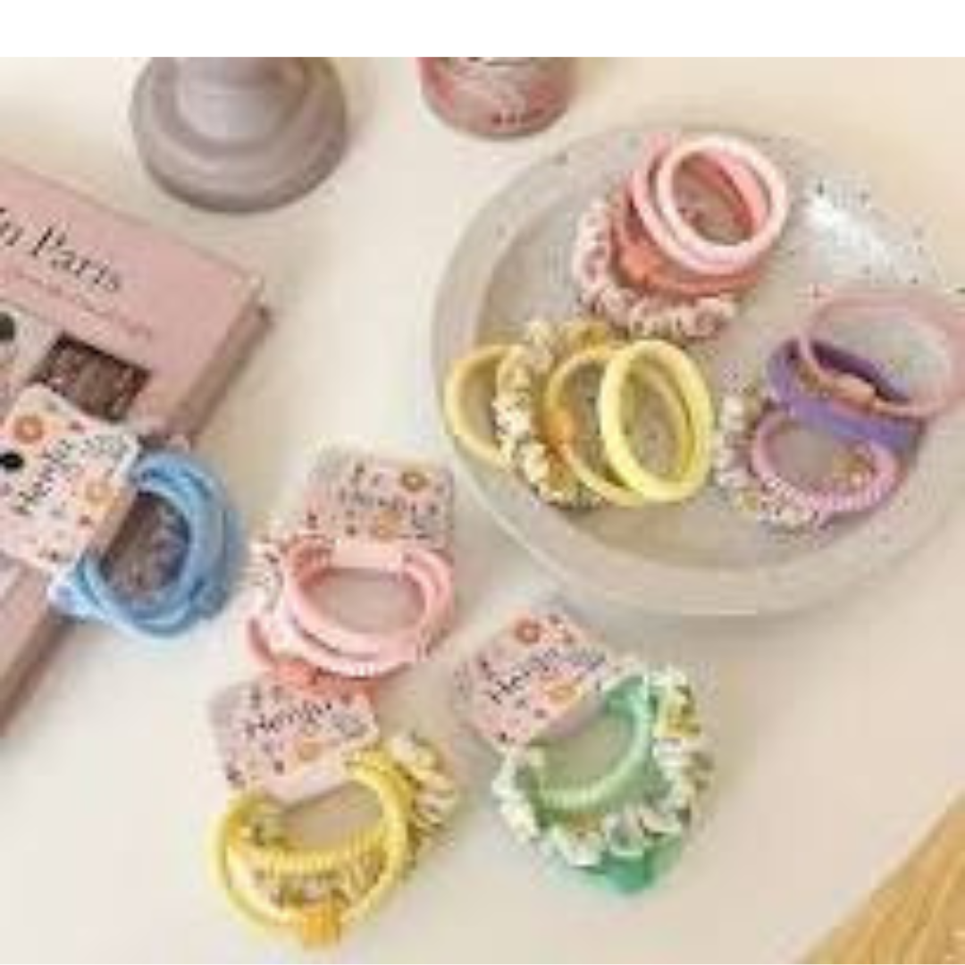 A multi pack of hair ties featuring small integrated decoative charms